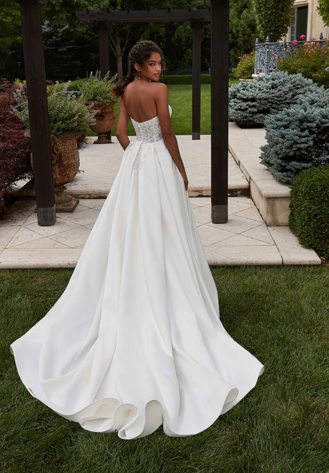 Our Patricia wedding dress is an elegant A-line with classic details. The strapless sweetheart bodice features embroidery with boning for added structure and support. The sleek, pleated satin skirt floats off the body in an A-line silhouette. We love the fun addition of pockets to the gown. Available at the Atlas Bridal Shop. Atlas Bridal Shop is a bridal shop in Toledo, Ohio. Designers include Morilee, Allure Bridal, Allure Couture, Maggie Sottero, Rebecca Ingram, Sottero Midgely and more. A Line Wedding Dress Sweetheart, Pleated Satin Skirt, Sweetheart Corset, Allure Couture, Bridal Studio, Corset Bodice, Classic Wedding Dress, Allure Bridal, Satin Skirt