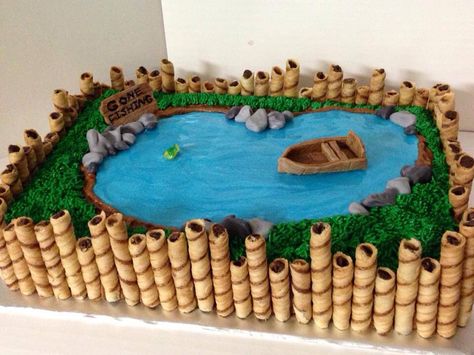 Fishing pond cake with pretty blue water. Going to add beavers to this and take away the boat per son's request.  Think I'll nail it?  LOL Torturi Baby Shower, Pond Cake, Fish Cake Birthday, Fishing Pond, Fishing Birthday Party, Fishing Party, Fishing Birthday, Cakes For Men, Fish Cake