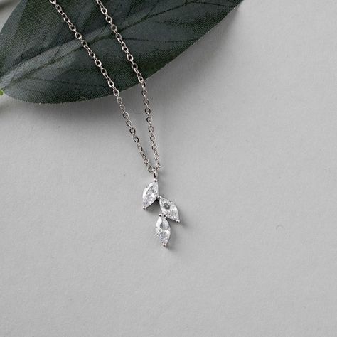 This minimalist style is created with three marquise leaf CZ stones and set in rhodium silver or gold plate. A tiny bright necklace for the bride or bridesmaids. The pendant is 5/8 of an inch long and the necklace is 16.5 inches with a two inch extender. #bridetobe24 #wesaidyes #weddingjewelryforsale #bridesmaidgifts #bridalaccessories #isaidyes #weddingaccessories Bright Necklace, Bridemaids Gifts, Silver Jewelry Fashion, Leaf Pendant, Wedding Jewelry Sets, Rose Gold Necklace, Bridesmaid Jewelry, Cz Stone, Minimalist Style