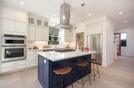 Kitchen with ceiling mounted range hood blue island and white cabinets Kitchen Island Range Hood, Kitchen Island Range, Kitchen Island With Cooktop, Kitchen Hood Ideas, Island With Stove, Kitchen Island With Stove, Kitchen Pantry Doors, Kitchen Hood Design, Types Of Kitchen