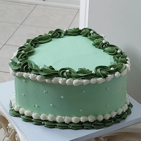 Mint green heart-shaped cake with white pearls on the side and dark green and white lining. By: Bhalavi Cakes Toronto/GTA/Markham based, small business Safe Green Cake, Green Cake 2 Tier, Dark Green Heart Cake, Green Heart Shaped Cake, Sage Green Heart Cake, Mint Green Cake Design, Green And Brown Cake, Dark Green Birthday Cake, Green Color Cake