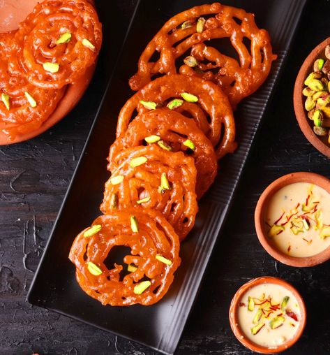 Homemade Kesar Jalebi is a classic Indian sweet which is made by deep-frying flour and then soaking ... Ingredients 3 cups of ghee or oil (for frying) 1 cup maida or all-purpose flour 2 tsp cornflour 1 tbsp dahi or yogurt 1 small pinch of red/orange food colour Rabri Recipe, Festive Dessert Recipes, Most Popular Desserts, Party Food Dessert, Pani Puri, Weekend Cooking, Sweet Recipe, Indian Kitchen, India Food