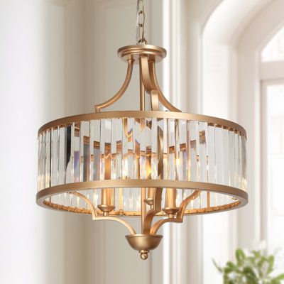 This 3-light drum chandelier is a focal point with its glam gold finish and simple drum design, evoking a high-end elegance without sacrificing the classic touch. Crafted from the gold metal, this chandelier features a drum work frame covered by transparent glass. Inside the frame sit three sophisticated candle-stick bases that support three lighting bulbs (E12/up to 40W/not included) to provide sufficient lighting. Suspended in you entryway, dining room, foyer or living room, this chandelier no Drum Chandelier Entryway, Gold Chandelier Entryway, Gold Bathroom Chandelier, Foyer Pendant Light Entryway, Office Chandelier Ideas, Gold Dining Room Light Fixture, Traditional Dining Room Lighting, Entryway Chandelier Foyers, Aesthetics House