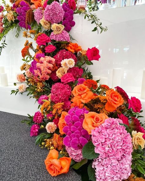 Vibrant Wedding Flower Arch, Orange Pink Flower Arrangements, Orange And Pink Floral Arrangements, Orange Pink And Red Wedding, Fuschia And Orange Wedding, Vibrant Floral Arrangements, Bright Floral Wedding Decor, Green Pink And Orange Wedding, Pink And Orange Flower Arrangements