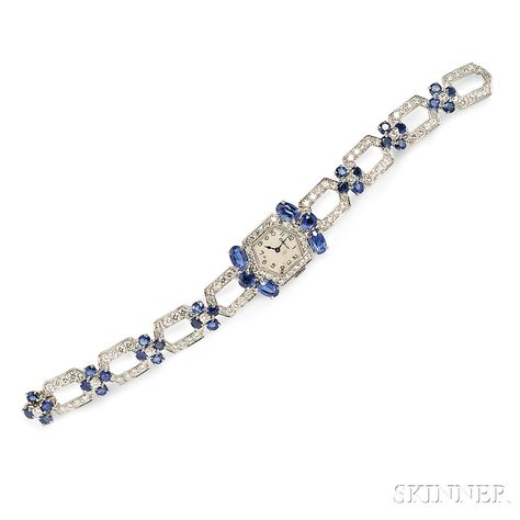 Platinum, Sapphire, and Diamond Wristwatch, Cartier, the white dial with Arabic numeral indicators, enclosing manual-wind European Watch & Clock Company Inc. 19-jewel movement, case and bracelet set with fancy-cut sapphires and full- and single-cut diamond melee, dial and clasp signed. Diamond Brooch Cartier, Cartier Diamond Bracelet, Art Deco Watch, Watch Clock, Diamond Brooch, European Cut Diamonds, Cartier Ring, White Dial, High Jewelry