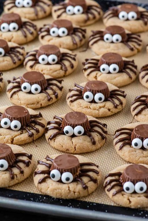 Soft and chewy peanut butter cookies topped with Reese's, melted chocolate, and candy eyes, these peanut butter spider cookies are both easy and fun to make. The perfect Halloween dessert for your next party! Reese’s Spider Cookies, Cute Halloween Potluck Ideas, Spider Snacks Halloween, Halloween Peanut Butter Spider Cookies, Spider Halloween Snacks, Peanut Butter Spider Cookies Recipe, Ritz Cracker Halloween Treats, Peanut Butter Halloween Cookies, Spider Sugar Cookies Halloween