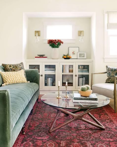 Perfectly styled living room features a red rug placed beneath a green velvet sofa positioned facing a styled glass and wood coffee table. Craftsman Living Rooms, Couch Cozy, Craftsman Living Room, Eclectic Living, Vintage Industrial Decor, Eclectic Bedroom, Eclectic Living Room, Green Sofa, Living Room Green