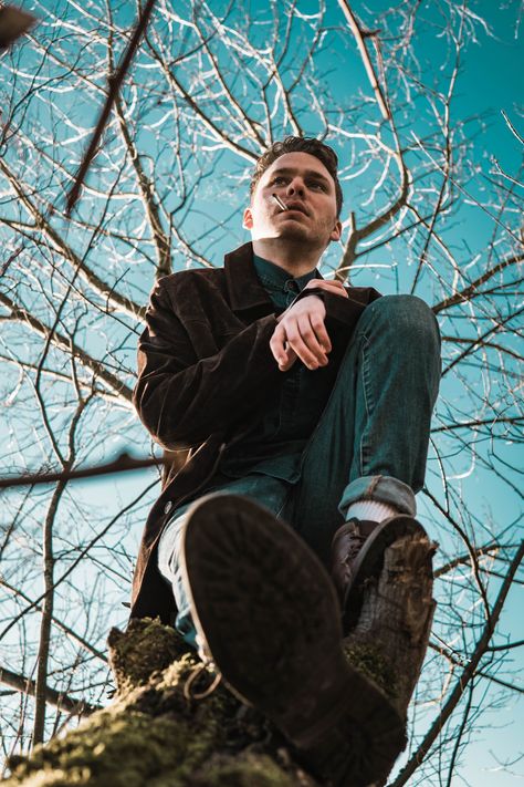 Mount Vernon, United States, I wanted to try and do a 70’s theme for this picture. My model really pulled it off very well, while the cigarette brought it more of that time period. I saw this fallen tree and thought about what kind of shot would look the best. I tried one low shot and from that point took 20 more. I feel like low angle shots can really show more emotion to what a person is thinking. This is my favorite shot from all of my shoots and I’m excited for me to keep going!, SONY, ILCE- Angle Photoshoot, Worm's Eye View Photography, Worms Eye View, Person Photography, Low Angle Shot, Types Of Shots, Photography Cheat Sheets, Film Photography Tips, Low Angle