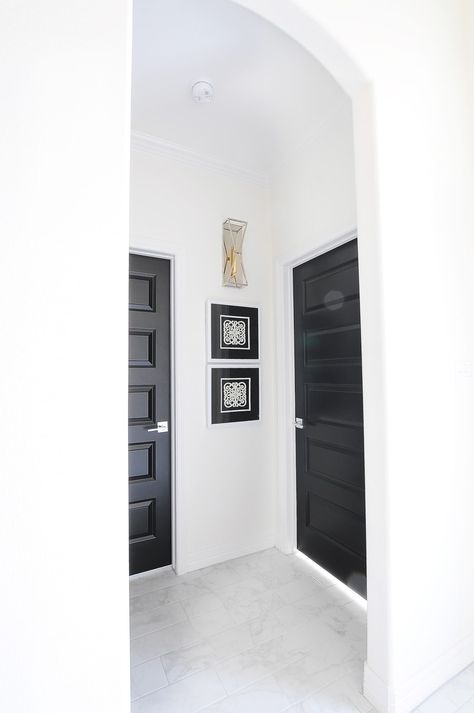 Tricorn black interior doors in an arched hallway with white trim and alabaster walls in a modern home. Tips, tricks on how to clean doors in your house. #homedecorideas #homedecoraccessories #homedecorating #homedecoronabudget #homedecoratingtips Dark Interior Doors, Painting Interior Doors Black, Black Interior Door, Dark Doors, Black Paint Color, Black Interior Doors, Alabaster White, White Doors, Dark Interiors