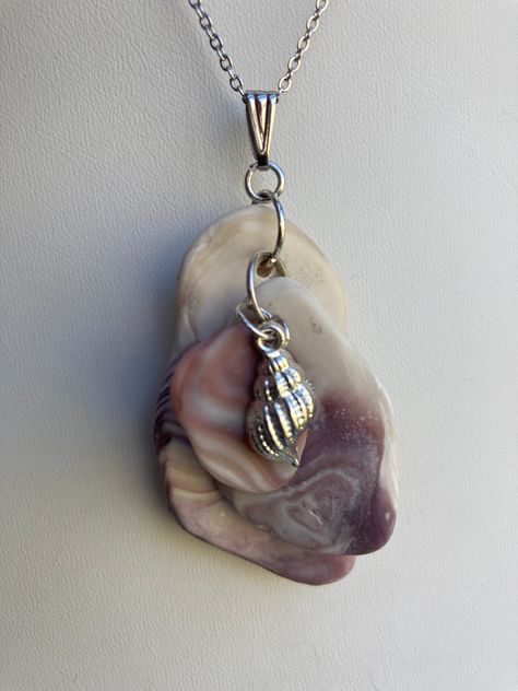 "Wampum Seashell choker pendant, sea shell clusters with all different types of purple shells and a Sterling plated shell charm on a sterling plater 20\" loop chain as seen in the last picture.  Unique seashell pendant measures 2 5/8\" X 1 1/8''. Makes a great summer choker necklace.  Sterling silver necklace is not included, it was used as DISPLAY ONLY.  But it can be purchased for $52.50 and necklace 20'' and  is stamped 925 Italy. You can compare the size of the shells to the $0.50 cent piece in the pictures. All my necklaces are different and would be considered one of a kind. View my collection of Kingman Arizona Turquoise here: https://www.etsy.com/shop/MoonwaterJewelryShop?section_id=28192591  I've been selling on eBay since 2003 Came to Etsy to sell jewelry. Returns and exchange de Different Types Of Purple, Types Of Purple, Seashell Choker, Gold Seashell Necklace, Summer Choker, Kingman Arizona, Sell Jewelry, Seashell Pendants, Shell Choker