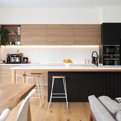 CompleteKitchens on Instagram: "The warm Prime Oak and cool Absolute Matt Black cabinetry work together to create a warm and modern feel. Milky white Palm Shade Caesarstone was chosen for the benchtop and splashback, which perfectly “disappear” in the space to provide the balance and contrast. The island’s support legs and frame are made of Tasmania Oak timber, stained to match the flooring, adding a sense of cohesion and sophistication to this edgy and modern kitchen space. #kitchendesigni White And Timber Kitchen, Hampton Kitchen, Black Cabinetry, Prime Oak, Modern Black Kitchen, House Renos, Timber Kitchen, Kitchen Concepts, Contemporary Kitchen Design