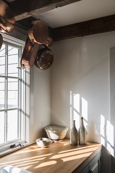 Additional hanging storage, courtesy of iron wall hooks affixed to the rafters. Esteves’ mother uses them to display copper pots and pans. Copper Pans Hanging, Minimalist Kitchen Design, Casa Vintage, Minimalist Interior Design, Farmhouse Style Kitchen, Modern Farmhouse Kitchens, Minimalist Home Decor, Wood Beams, Minimalist Kitchen