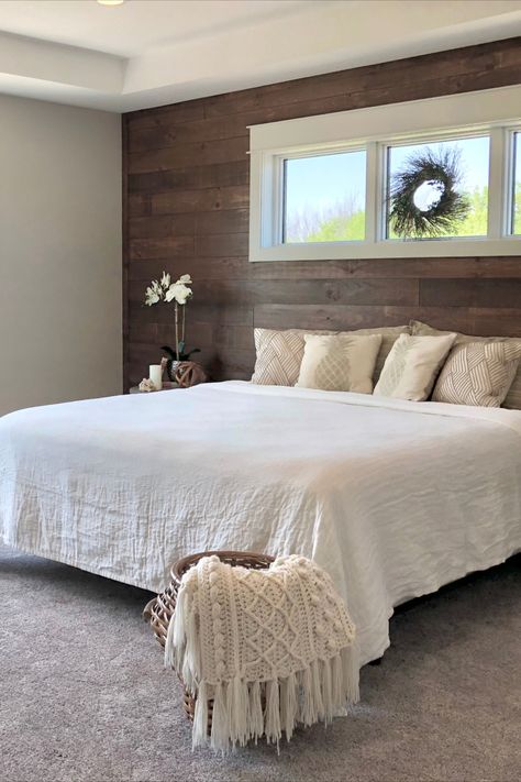 We used shiplap on a feature wall in the master bedroom. We used a stain to add warmth with the bedding and accessories in muted tones for an aesthetically pleasing feeling. Grey Shiplap Wall Bedroom, Brown Shiplap Wall Bedroom, Master Bedrooms With Accent Wall Shiplap, Stained Shiplap Wall Bedroom, Wood Accent Wall Bedroom With Window, Shiplap Master Bed Wall, Wood Plank Wall Bedroom, Ship Lapped Walls Bedroom, Feature Wall With Window