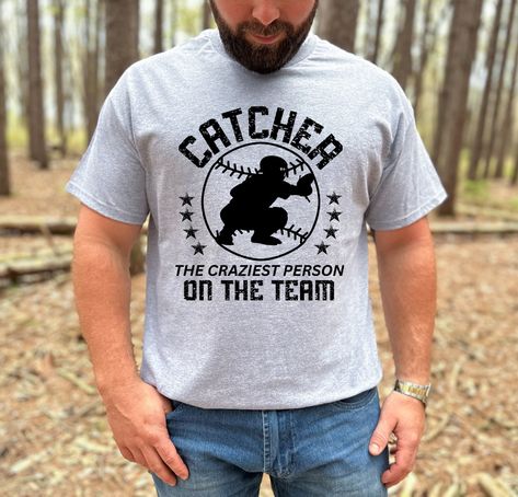 This funny Catcher shirt, Softball Catcher t shirt, and is a perfect Catcher gift for the craziest person on the team! PRODUCTION BEGINS SAME DAY. Garments are printed with DTG printing (Direct-to-Garment).  DTG printing which infuses the design  directly onto the fabric using advanced inkjet technology. There is nothing to peel off as with vinyl as the ink is infused with the material. Personalization of the garment's back is available for all of our shirts (not included in shirt price). Follow Softball Catcher Shirts, Sport Ideas, Softball Catcher, Crazy Person, Softball Stuff, Dtg Printing, Sports Shirts, Shirt Price, Shirt Ideas