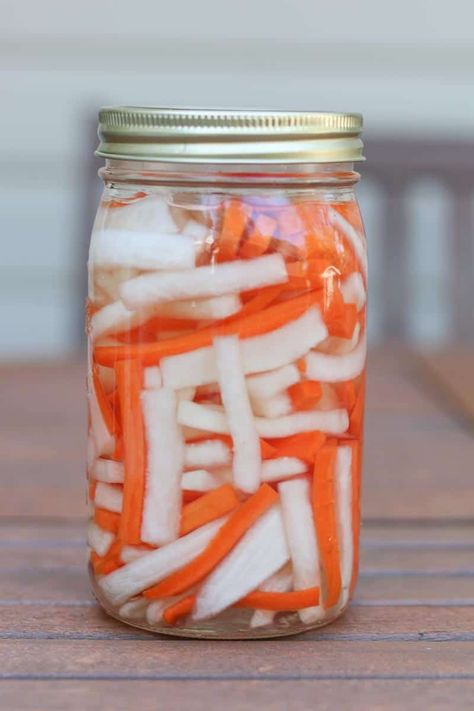 Vietnamese pickled daikon and carrots are a sweet and tangy condiment used on Banh Mi sandwiches. They are easy to make and can be enjoyed additionally as a crunchy snack or a topping for salads, sandwiches, and rice bowls. Pickled Daikon And Carrots, Pickled Carrots And Daikon, Pickles Homemade, Fermented Recipes, Pickled Daikon, Vietnamese Sandwich, Banh Mi Sandwich, Vietnamese Noodles, Pickling Salt