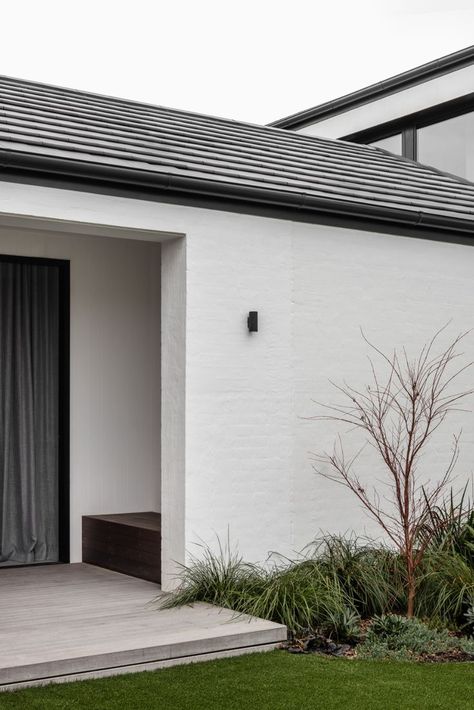 This large family residence is composed of two masonry and tiled gable roof structures, a contemporary but contextual response to the more traditional homes in the leafy hillside street. #melbourne #home #modern #contemporary #builder Modern Brick House Exterior, White Brick House Exterior, Rendered Houses, Painted Brick Exteriors, Melbourne Home, White Exterior Houses, Painted Brick House, Exterior Tiles, House Cladding