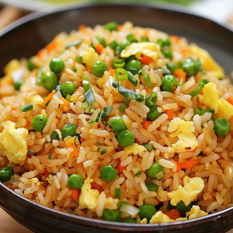 🍚 Make your dinner special with our Special Fried Rice - Egg Fried Rice! Filling and flavorful! #RiceLovers Special Fried Rice - Egg Fried Rice Ingredients: Cooked rice (2 cups (370 g)) Eggs (3) Peas and carrots, frozen (1 cup (150 g)) Onion, chopped (1) Soy sauce (3 tbsp (45 ml)) Sesame oil (1 tbsp (15 ml)) Green onions, chopped (for garnish) Instructions: Scramble eggs in a pan, set aside. Sauté onions, add peas and carrots, cook until tender. Add rice, eggs, soy sauce, and sesame oil. ... Fried Rice Ingredients, Sauté Onions, Special Fried Rice, Rice Egg, Scramble Eggs, Fried Rice With Egg, Peas And Carrots, Egg Fried Rice, Instagram Recipes