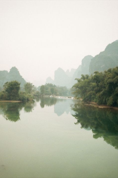 35mm film photograph by Rhea Cutillo. Captured in Yangshuo, China. Blue clear skies blending with green mountainscapes, trees and the reflective clear waters of the Emerald River. #film, #kodak, #fuji , #photographer, #travel, #artist Yangshuo China, Travel Artist, Green Landscapes, Photographer Travel, Film Photography 35mm, China Blue, Green Landscape, Clear Sky, 35mm Film