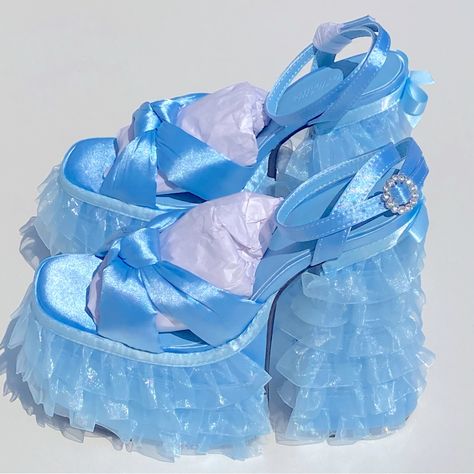 Sugar Thrillz Platform Layered Lace Satin Crystal Blue Sandals Heels Size 9 Feature A Satin Construction, A Ruffled Tulle Trim On The Platform Soles And Block Heels, A Bow Trim In The Back, Knotted Foot Uppers, And Rhinestone Buckle Closures. Details: Light Blue Man Made Materials 6" Heel 3" Platform Sugar Thrillz Shoes, Ruffle Heels, Blue Sandals Heels, Pink Slides, Satin Sandals, Dr Shoes, Fringe Sandals, Funky Shoes, Sugar Thrillz