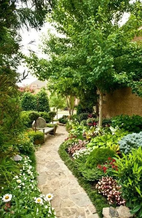 a gorgeous blooming side yard with lots of greenery and various flowers, a tree and a wooden bench feels like a secret garden Fairy Path, Yard Decor Ideas, Side Yard Garden, Designing A Garden, Japanese Inspired Garden, Stone Pavement, Concrete Path, Brick Path, Side Yards