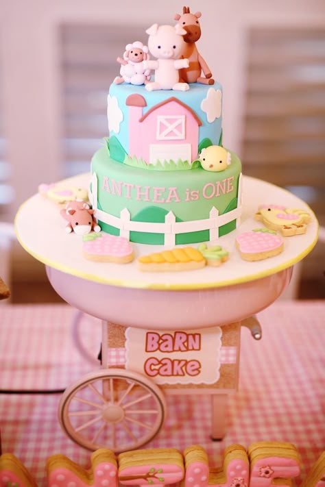 Pink Barnyard Birthday Cake via Kara's Party Ideas | Party ideas, supplies, tutorials, recipes, games, favors and more! KarasPartyIdeas.com Barnyard Birthday Cake, Pink Barnyard Birthday, Girls Farm Birthday, Farm Birthday Cakes, Barnyard Cake, Barnyard Birthday Party, 2nd Birthday Party For Girl, Farm Theme Birthday, Farm Animals Birthday Party