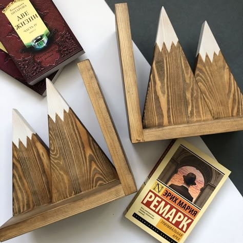 Wooden Book ends is convenient and practical way to store your favorite books on the shelves. Wood book ends are a great gift for book lovers and book club members.We offer you set of 2 wooden bookends, which are made by hand. Our set of 2 bookends are made in a style of mountains to look great in a rustic and farmhouse decor or a naturethemed room, such as woodland nursery.Deminitions: 8.7 x 8.7 x 4.7 incWooden bookends are made by hand in a home workshop. Made of larch wood and treated with sp Wooden Book Ends Diy, Wood Books, Diy Book Ends Wood, Diy Wooden Bookends, Simple Woodworking Projects, Diy Bookends Easy, Bookends Ideas, Wooden Book Accessories, Wood Book Holder