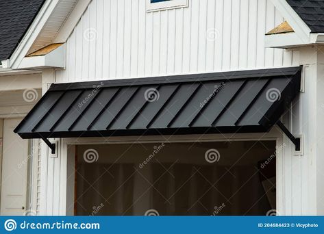 Black awning door stock image. Image of exterior, front - 204684423 Metal Awning Over Front Door, Modern Door Awning, Modern Black Awning, Metal Roof Awning Over Door, Black Metal Awning Over Garage Door, Sliding Door Awnings Exterior, Awnings Over Windows House, Front Door Awning Ideas Brick House, Awning Front Door