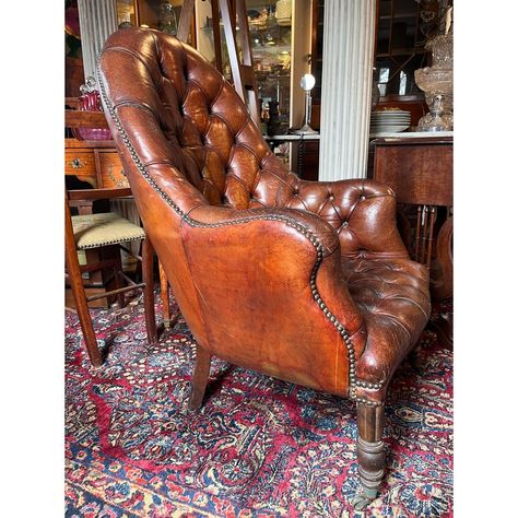 Stunning antique English library chair with gorgeous deep tufted leather, beautiful wooden legs with brass casters and antique nails. This chair has a stunning patina and will be the statement of any room!  Measuring 27" Wide x 27" Deep x 40" Tall Antique Reading Chair, Leather Library Chair, Library Antique, Antique Nails, Victorian Office Chair, Antique Chair Styles, Vintage Leather Chair Overstock, Antique Leather Office Chair, Cozy Town