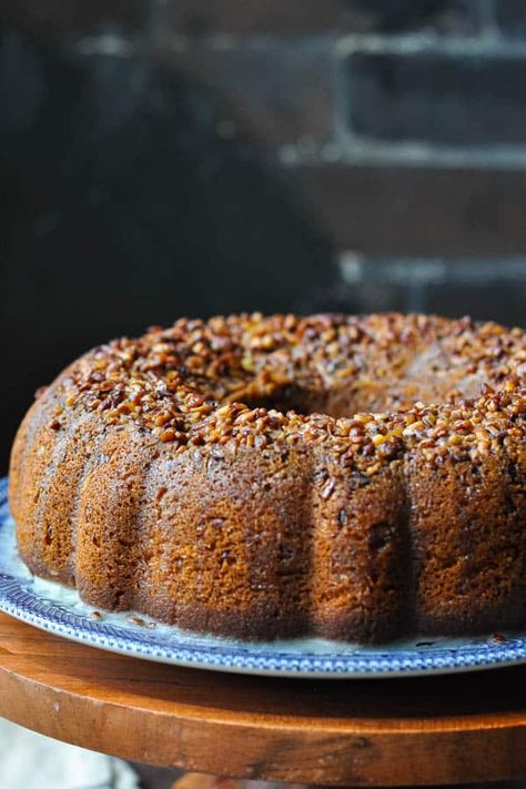 A perfect celebratory dessert for the holidays! This easy Rum Cake recipe starts with a box of cake mix for a moist, flavorful and quick yellow Bundt cake that's topped with pecans and soaked with a rich, butter-rum glaze. Easy Cake Recipe | Christmas Dessert | Thanksgiving Dessert | New Year's Eve Vegan Rum Cake, Yule Feast, Rum Soaked Cake, Tortuga Rum Cake, Bacardi Rum Cake, Rum Cake Recipe, Whiskey Cake, Glaze For Cake, Bacardi Rum