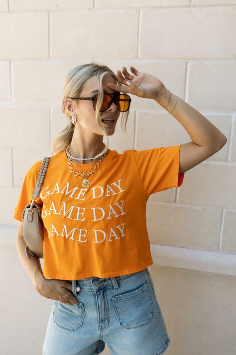 Close up of model wearing the Game Day Orange Top. This is an orange cropped top that says Game Day in white 3x, short sleeve. Aesthetic Game Day Outfit, Ut Gameday Outfit, Orange Gameday Outfit, College Gameday Outfits Football, Casual Game Day Outfit, Game Day Outfit College, Cute Gameday Outfits, Game Day Outfit Fall, Clemson Gameday Outfit