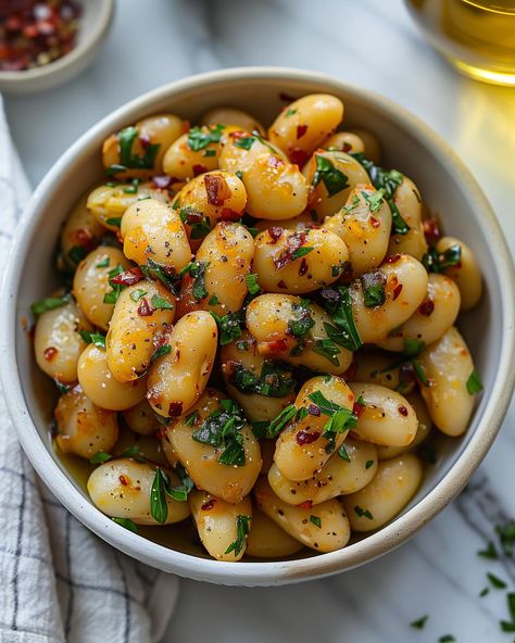 Marinated Butter Beans🌱🥣 Savour these delicious marinated butter beans, perfect as a side dish or a light snack🤤 Follow @plantiful.palate for more recipes🗒️ Recipe: Ingredients: - 400g cooked butter beans (canned or home-cooked) - 2 tablespoons olive oil - 1 tablespoon lemon juice - 2 cloves garlic, minced - 1/2 teaspoon red chilli flakes - 1/2 teaspoon smoked paprika - Salt and pepper, to taste - Fresh parsley, chopped (for garnish) Method: 1. If using canned butter beans, rinse and drain... Butter Bean Recipes, Butter Beans Recipe, Canned Butter, Light Snacks, Vegan Foodie, Butter Beans, Eating Plans, Veg Recipes, Bean Recipes