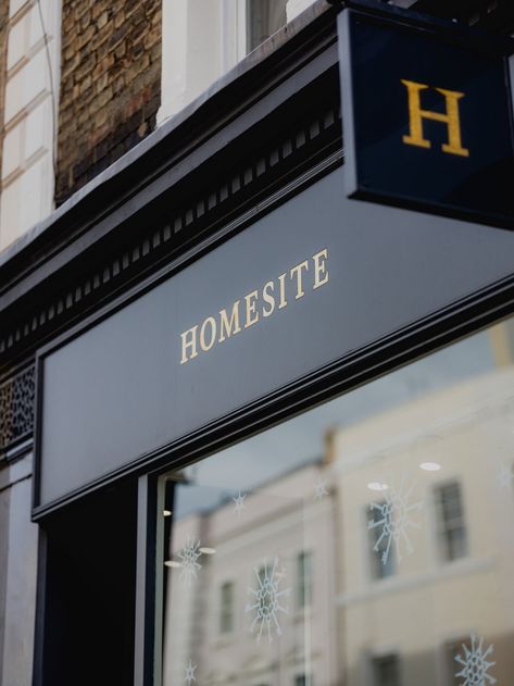 A photograph of a dark grey shopfront window with gold lettering. Real Estate Office Exterior, Real Estate Brokerage Office Design, Estate Agent Office, Leamington Spa, Island Homes, Office Signage, Christmas Window Display, Real Estate Office, Sales Office