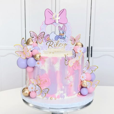 Pink and Purple Daisy Duck 8” Cake with Cake Balls and Butterflies Minnie Mouse Daisy Duck Cake, Daisy And Butterfly Cake, Minnie Mouse And Daisy Duck Cake, Purple Minnie Mouse Cake, Pink And Purple Butterfly Cake, Pink And Purple Cake Ideas, Daisy Cake Birthday, Butterfly Cake Design, Pink Butterfly Cake