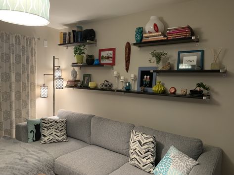 Floating Shelves Living Room Long Wall, Industrial Shelves Above Couch, 4 Shelves On Wall Arrangement, Floating Shelves Living Room Behind Couch, Living Room Picture Ledge Over Couch, Living Room Wall Shelves Above Couch, Book Shelf Above Couch, Floating Shelves Behind Sofa, Long Wall Shelf Living Room