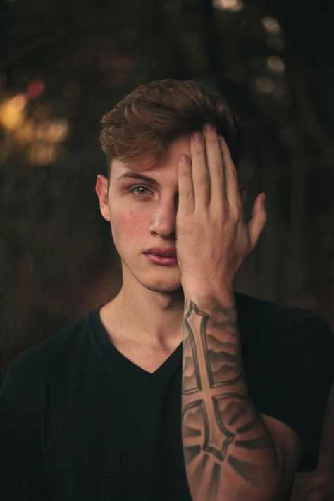 Photo of Tattooed Man Covering Eye with Hand · Free Stock Photo Hand Over Eyes Reference, Hand Covering Eyes Reference, Black Tshirt Outfit, Painless Tattoo, Hands On Face, Bring Back Lost Lover, Tshirt Outfit, Hand Reference, Human Poses Reference