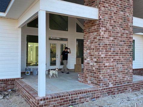 White Farmhouse Red Brick, White Home With Red Brick, Brick Outdoor Chimney, Red Brick Skirting House, Red Brick And White House Exterior, White Farmhouse With Brick Skirt, Red Brick White Mortar, White Siding With Red Brick, Brick Back Porch Ideas