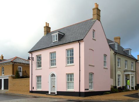 These beautiful new properties at Poundbury, The Prince of Wales’ ground breaking development in Dorchester, feature distinctive, classically designed houses, apartments and period-style terraces.  weberend OCR, one-coat base render, offers a variety of finishing styles and features, and was specified for its ease and speed of application which is proven to save days of on-site labour. #poundbury #render #pink #newbuild Pink Rendered House, Rendered House, House Colour, Exterior House Color, Ground Breaking, Exam Prep, Pink Houses, New Property, Exterior House