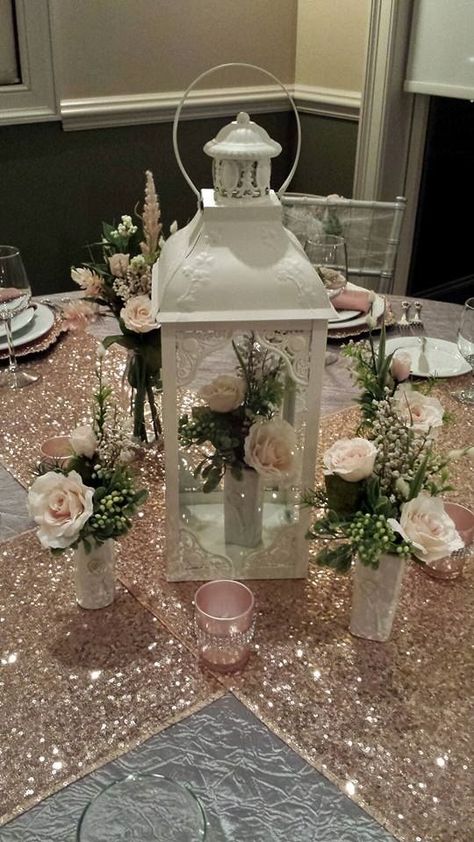 Blush pink table scape with sequin runners! But in Teresa colors White And Rose Gold Quinceanera Theme, Dusty Rose And Gold Wedding Centerpieces, Sweet 16 Blush Pink Theme, Rose Gold Quince Centerpieces, Pink Lanterns Decor, Quinceanera Table Decorations Pink, Quiencera Flower Theme, Pink Quinceanera Table Decorations, Decorating Ideas For Quinceanera