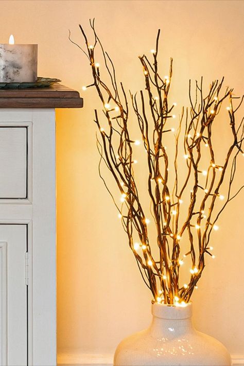 Create a warm and inviting ambiance in your living room with these enchanting indoor lighting ideas! From soft candles that twinkle like stars to elegant fairy lights that cast a gentle glow, discover the perfect ways to infuse coziness into your space ✨ Fall Garland Diy, Cosy Living Room Ideas, Twigs Decor, Lighted Tree Branches, Cosy Home Decor, Living Room Candles, Cosy Decor, Twig Lights, Autumn Essentials