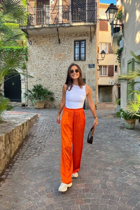 A bright, bold shade of orange is a must-have for our summer outfits! Pair your favorite white tank top with goregous orange pants. Orange Pants Outfit Summer, Orange Tank Top Outfit, Orange Pants Outfit, Sunkissed Skin, Summer Pants Outfits, Orange Pants, Summer Shades, Tropical Vacation, Find Beauty