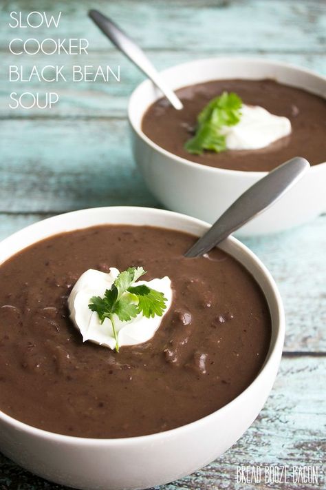 Creamy Slow Cooker Black Bean Soup is a comforting meal topped with sour cream for a dish that's fit for a restaurant! Black Bean Soup Crock Pot, Slow Cooker Black Bean Soup, Slow Cooker Black Beans, Bread Booze Bacon, Black Bean Recipes, Crock Pot Recipes, Slow Cooker Desserts, Bean Soup Recipes, Black Bean Soup