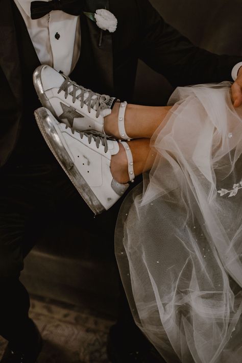 A bride's shoes are on her groom's lap. She wears Golden Goose sneakers with silver accents. Golden Goose Wedding Sneakers, Bridal Golden Goose, Bride Golden Goose, Wedding Day Sneakers, Golden Goose Wedding Shoes, Golden Goose Wedding, Wedding Golden Goose, Golden Goose Aesthetic, Glitter Dress Outfit