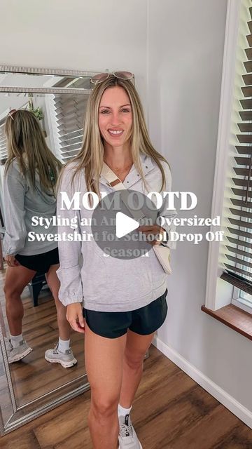 Aryn Harb | AMAZON FASHION | AFFORDABLE LIFESTYLE on Instagram: "Mom Outfit Idea! For 🔗 comment “shop” and I will send it to your Inbox!
Found the cutest gray pullover sweatshirt on Amazon! It’s oversized! Had button front snaps! It comes in four color options! Such a good comfy mom outfit must have !
Can’t believe we are prepping for back to school! This is such a good staple to wear for school drop off or car rider pickup! 
Paired it with my favorite gym shorts and crew socks with my on cloud sneakers and mom bag! 
🍁🍂🍁🍂
Hoodie is so good if your kids are in Friday night football games! 
Folllow me @vogueonaryn for more casual mom outfit ideas! 
Sweatshirt is linked on my Amazon storefront 

#momoutfits #sweatshirtseason #hoodie #momootd #amazonfashionfinds #falloutfitideas #momstyle Sporty Mom Outfits, Outfit Ideas Sweatshirt, Comfy Mom Outfits, On Cloud Sneakers, Sahm Outfits, Mom Outfit Ideas, Bag Hoodie, Cloud Sneakers, Car Rider