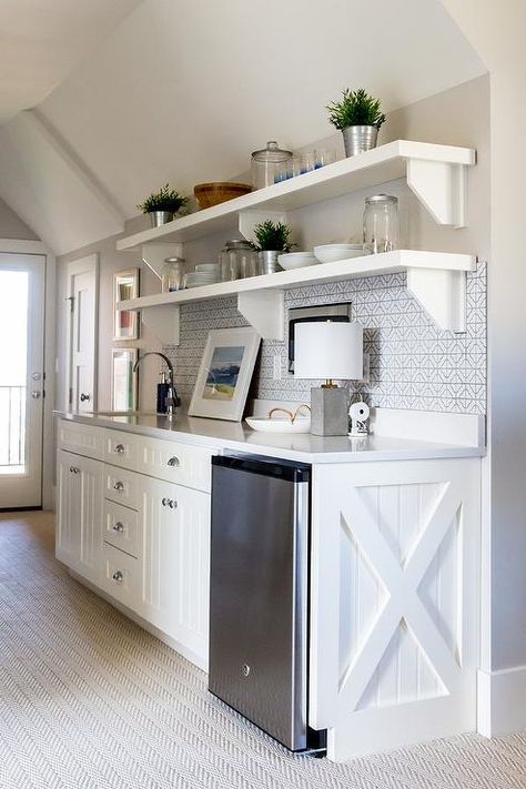 Under a sloped ceiling, a white and gray butler's pantry features white beadboard cabinets accented with polished nickel cup pulls and an x-trim and is fitted with a stainless steel mini fridge positioned under a white quartz countertop. Kitchen Cabinets Painted, Basement Kitchenette, Small Kitchenette, Cabinets Painted, Painted Kitchen Cabinets Colors, Basement Kitchen, Cabinet Paint Colors, Cottage Interior, Studio Kitchen