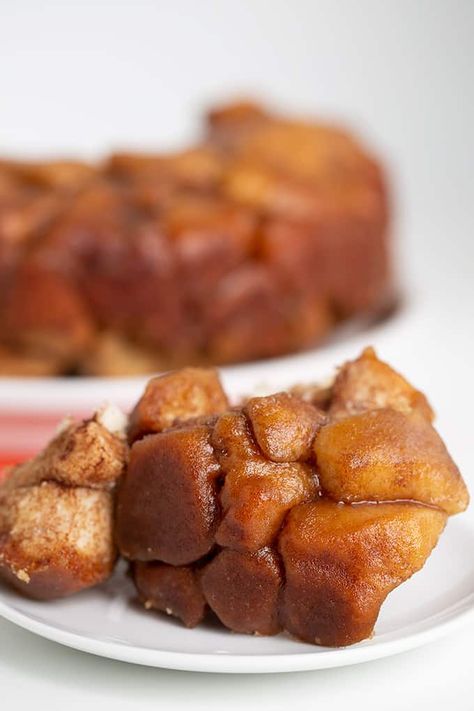 Easy Monkey Bread - This Quick and Easy Monkey Bread is made with biscuits that have been chopped into quarters and rolled in cinnamon and sugar. It’s baked to perfection in a bundt pan and inverted on a plate so the warm gooey brown sugar and butter coat the top and sides of the monkey bread. This quick monkey bread tastes great served warm or at room temperature and will quickly become one of your go-to dessert recipes. It's fun to eat and will save on dirty dishes! #semihomemade #desserts Quick Monkey Bread, Easy Monkey Bread, Dirty Dishes, Monkey Bread, Bundt Pan, Cinnamon Sugar, Cookie Dough, Bread Recipes, Brown Sugar