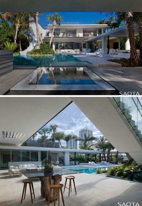 This modern house has a swimming pool with a slide, an outdoor lounge, an alfresco dining area and a BBQ/kitchen. #Landscaping #SwimmingPool #Deck Modern House With Pool, Deck Swimming Pool, House In Miami, Palm Springs House, Luxury Villa Design, Alfresco Dining Area, Large Deck, Miami Houses, Bbq Kitchen