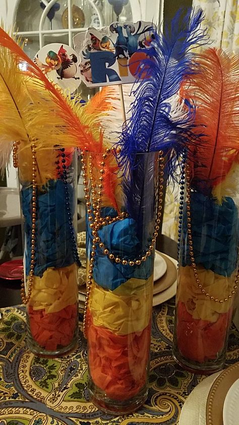 Disney Rio-themed centerpieces. Just tissue paper, large vases, feathers and pics on sticks. Rio Carnival Centerpieces, Rio Hoco Theme, Rio Carnival Prom Theme, Rio Themed Party, Rio Birthday Party Ideas, Rio Themed Birthday Party, Rio Carnival Theme Party, Rio Birthday Parties, Carnival Centerpieces