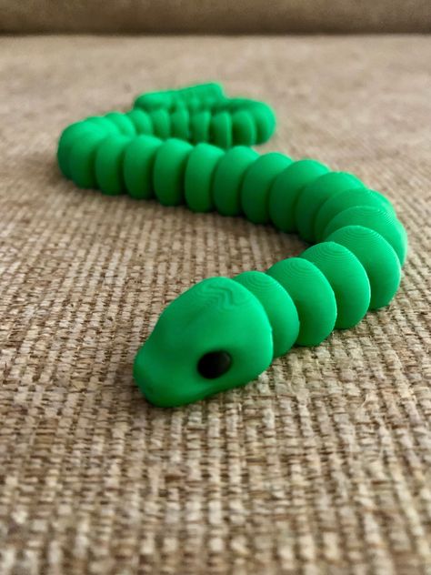 Zou3d Cute Snake Fidget Toy 3D Printed Flexible Desk Toy, Multi-Color Articulating Fun, Unique Gift, Snake Fidget, 3D Printed Flexi Toy 🐍Introducing the Zou3d Cute Snake Fidget Toy, a 14" long 3D printed flexible snake that brings multi-color articulating fun to your workspace or home! Crafted from high-quality PLA plastic, this unique gift is perfect for anyone who loves fidgeting or enjoys collecting fascinating toys. The detailed design ensures smooth articulation, making it a delightful and engaging piece to play with. 🌈 Its vibrant, multi-color appearance adds a splash of color to any setting, and its flexible construction ensures hours of endless fun. This 3D printed fidget is a playful addition to your collection and a unique gift for birthdays, parties, or any special occasion. P Snake Cute, Flexible Desk, Desk Toy, Cute Snake, Print Ideas, Desk Toys, Detailed Design, Fidget Toy, Fidget Toys