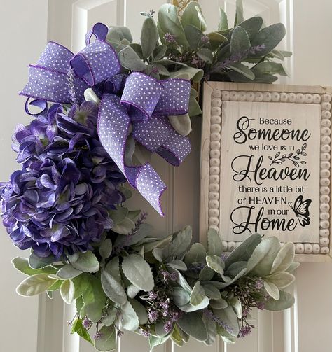 This beautifully crafted wreath, is  handmade on a grapevine base and adorned with artificial silk hydrangeas in a stunning shade of purple, with a wooden heaven sign attached. This is a thoughtful and heartfelt way to honor the memory of a loved one. Perfect for use as a sympathy gift or memorial decoration, this wreath is a lasting tribute that will bring comfort and solace to those grieving the loss of someone special. Suitable for display on a door or as part of a home décor arrangement, this wreath is a unique and meaningful addition to any space.  Measurements: 18 x18 inches and 5 inches deep. All of our wreaths can be hung up outdoors if you wish but we recommend it be a covered area away from harsh weather.   Our wreaths are thoughtfully and carefully handmade in our shop❤️. Celebration Of Life Wreath, Purple Celebration Of Life Decorations, Purple Door Wreath, Memorial Wreath, Purple Awareness Ribbon Wreath, Purple Everyday Wreath, Deco Mesh Wreaths Tutorials, Purple Hydrangea, Purple Wreath