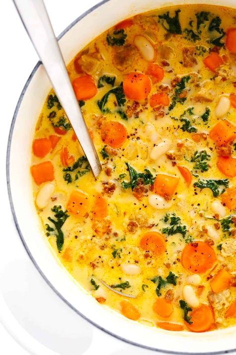 This Creamy Sweet Potato and Sausage Soup recipe is made with seasonal veggies, kale, white beans, and a creamy, garlicky, paprika-sage broth. Potato And Sausage Soup, Sweet Potato And Sausage, Sweet Potato Sausage, Potato And Sausage, Potato Sausage, Seasonal Veggies, Sausage Soup Recipes, Sage Sausage, Ground Italian Sausage